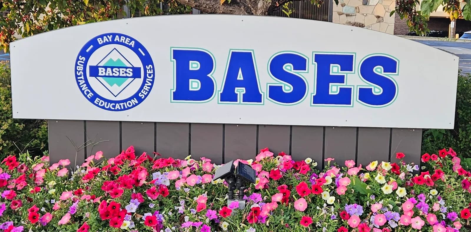 BASES road side sign with flowers.